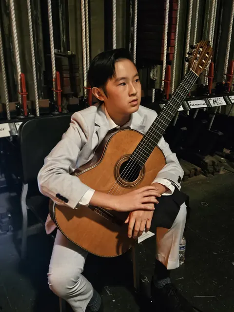 Justin Chen backstage with his classical guitar