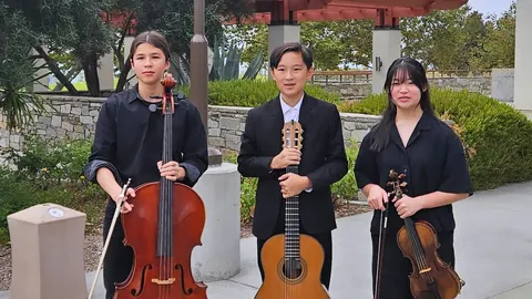 Justin Chen with a cellist and a violinist