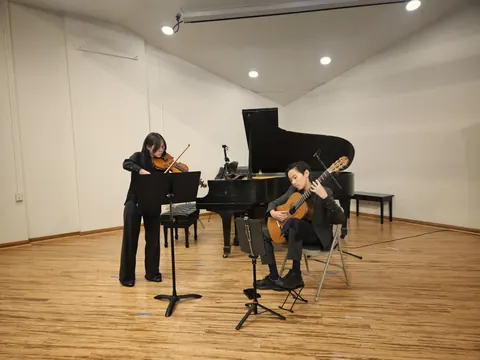 Justin Chen performing in a guitar and violin duo