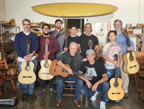 Justin Chen with musicians in a guitar workshop