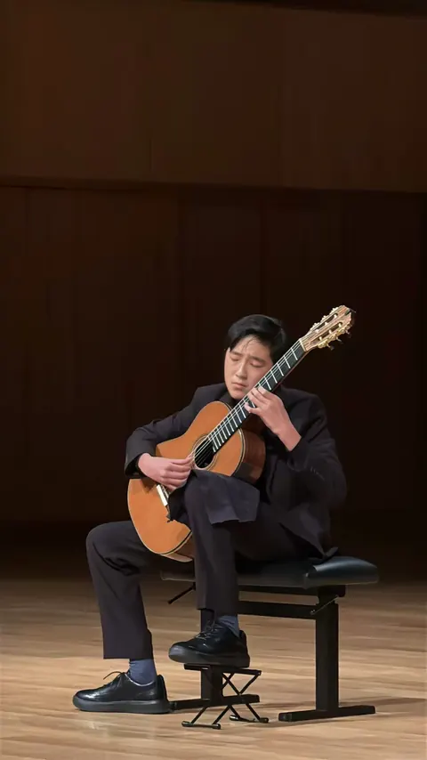 Justin Chen performing on stage