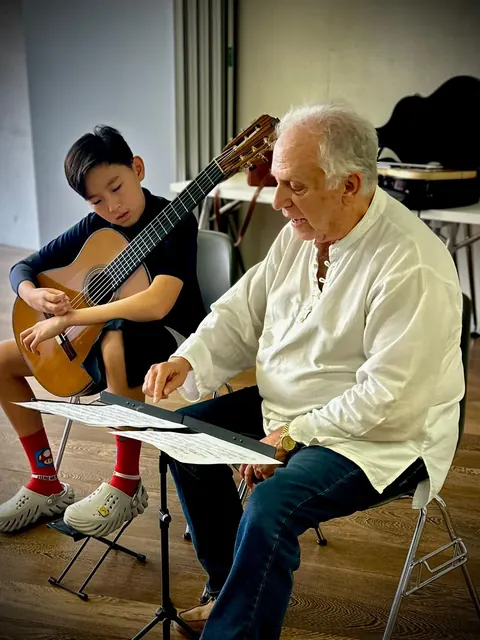 Justin Chen playing for a mentor in Granada, Spain