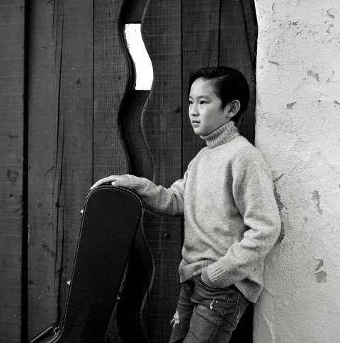 Justin Chen with his guitar case