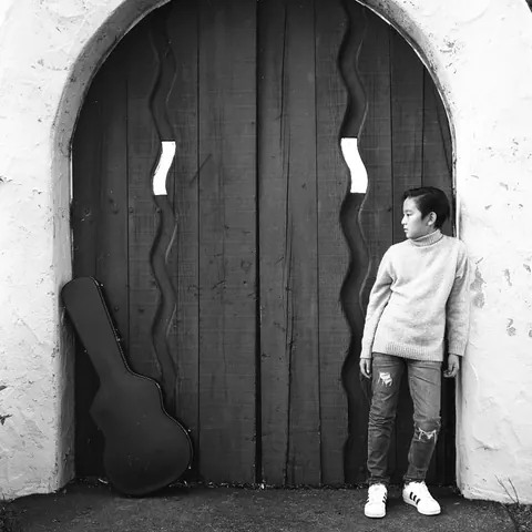 Justin Chen with his guitar case