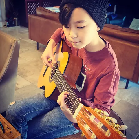 Justin Chen practicing classical guitar