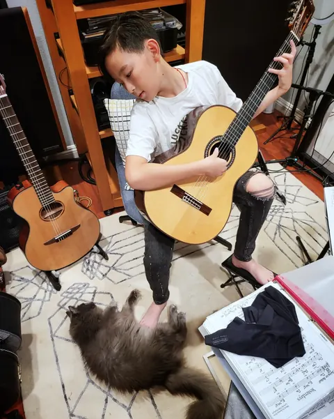 Justin Chen practicing classical guitar