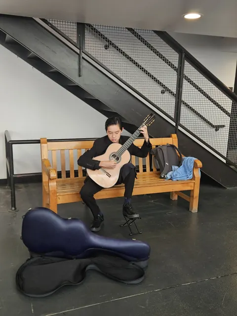 Justin Chen practicing classical guitar