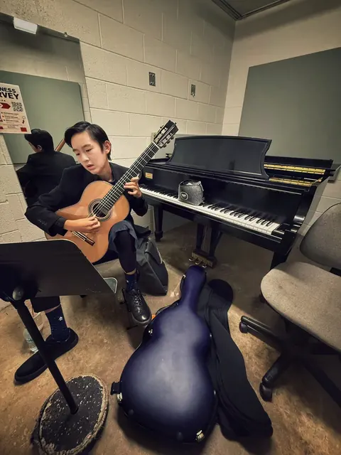 Justin Chen practicing classical guitar