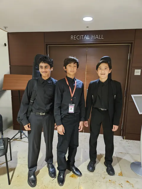 Justin Chen with fellow musicians at a recital hall