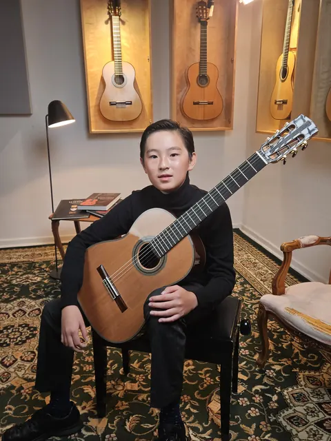 Justin Chen with his classical guitar at Siccas Guitars