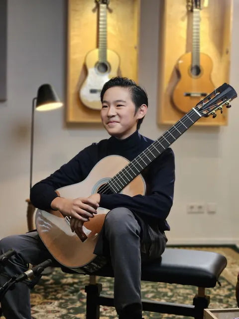 Justin Chen with his classical guitar at Siccas Guitars