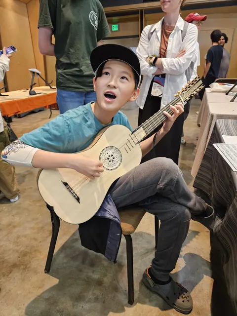 Justin Chen trying a guitar